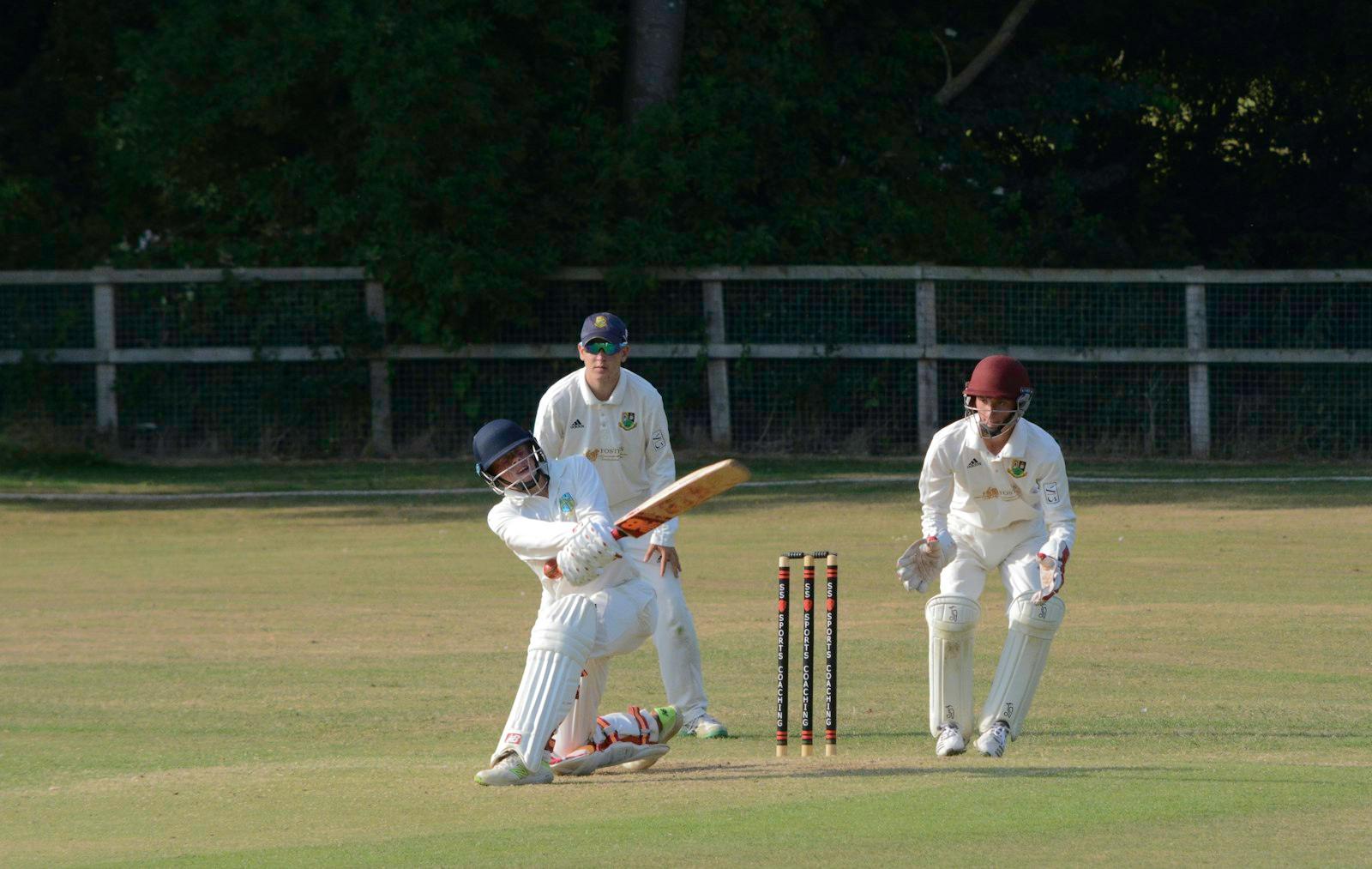 Batter playing a shot in front of the wicket-keeper