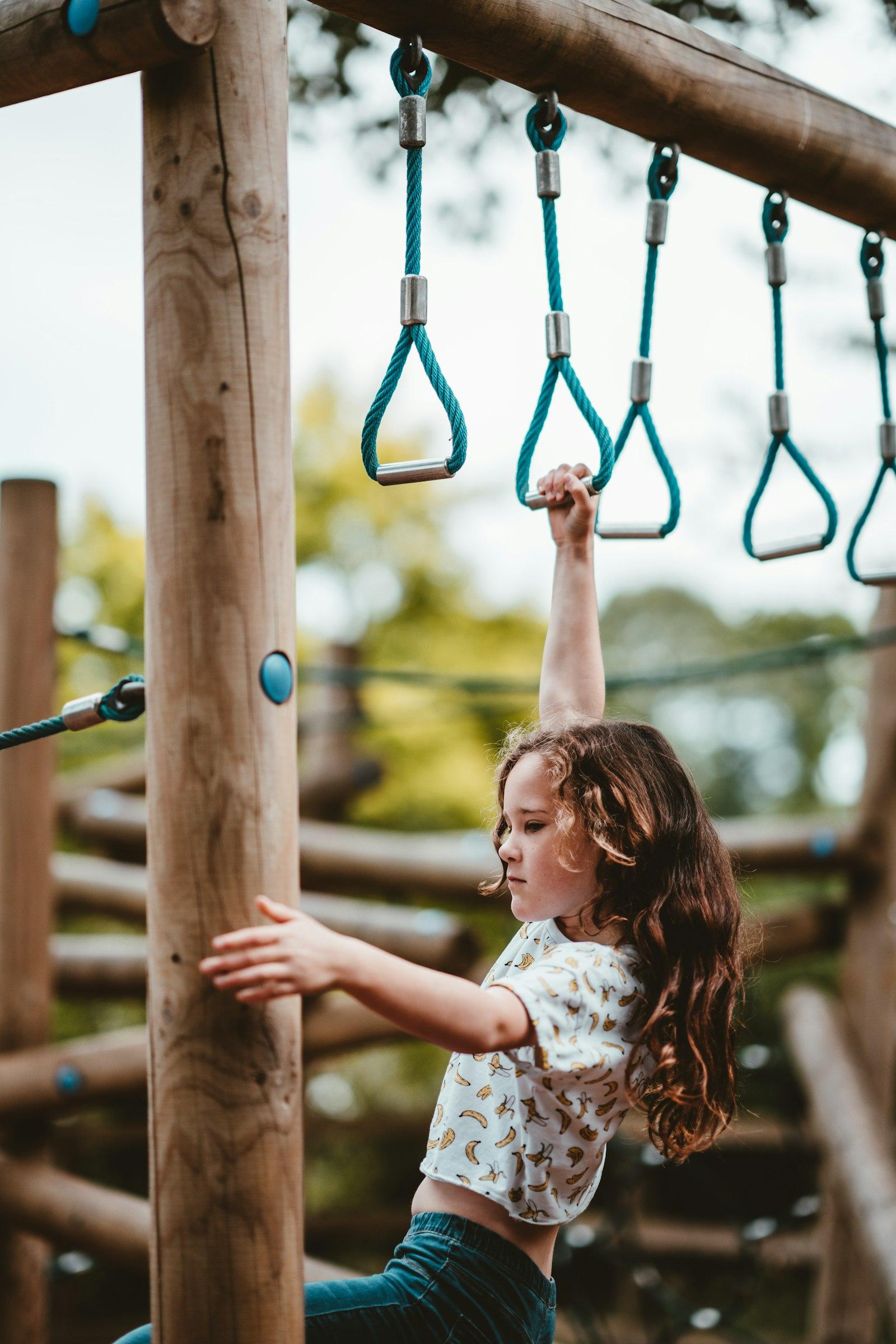 A child climbing on playground monkey bars